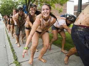 First year Human Kinetics students take part in an University of Ottawa Week 101 initiation activity as they walk hand-in-hand along King Edward Ave Thursday, September 4, 2014. The students were covered in various foods included cat food, ketchup, mustard, soy sauce. They eventually got hosed off by Ottawa firefighters at Station 13. Darren Brown/Ottawa Citizen)