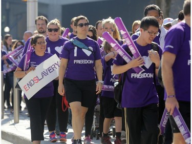 Freedom Walk participants walking up Colonel By Dr. from Convention Centre in downtown Ottawa, Saturday, September 27, 2014. Anti-human trafficking organizations are celebrating their fifth annual Freedom Walk, but first in Ottawa. They raise funds and hope to increase awareness to fight human trafficking, a growing problem in Canada (and around the world).