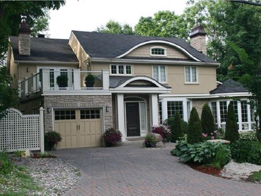 Nestled in gardens among towering maples, this elegant, renovated home marries the best of old and new. Spacious, with a warm Cotswold gold stucco and stone exterior, the home is replete with crown mouldings, bevelled French doors and Palladian windows. Corinthian columns separate the two-storey foyer and the luxurious living and dining rooms.