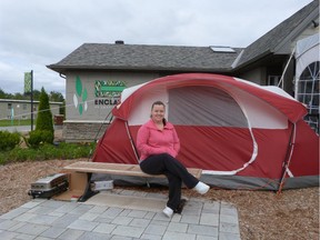 Prospective buyer Ashley Lamothe takes a turn waiting in line Friday so her husband, who has been camping out at the Minto Enclave sales site since Wednesday, could get some sleep in a bed.