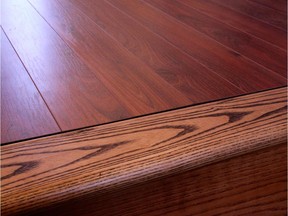 The laminate floor (top) looks no less authentic than the real wood stair tread next to it. Laminates are easy to install yourself, are durable and eliminate the need for finishing.