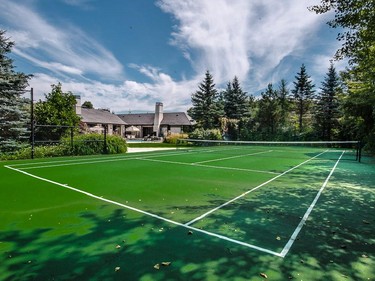 The backyard includes a tennis court.