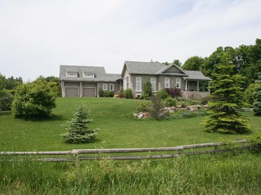 This rural Kanata family home was inspired by one featured on the PBS show Hometime. Key features include impressive vaulted ceilings and large windows to connect to the country setting. An open-concept floor plan and an inset outdoor patio, accessible from several rooms of the home, allow for socializing with family and friends.