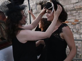 Harvest Noir fashion enthusiasts took part in a recent fashion flash mob on Chaudiere Island to promote the upcoming pop-up picnic extravaganza on Sept. 27. Organizer Samantha Biron get last-minute adjustments to her eclectic fascinator.