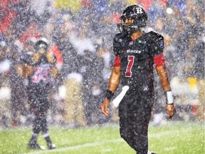 Henry Burris of the Ottawa Redblacks walks in the rain against the BC Lions during second half action at TD Place in Ottawa, Sept. 5, 2014.