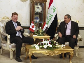 Canadian Foreign Minister John Baird, left, meets with Iraqi counterpart Hoshyar Zebari in Baghdad, Iraq, Wednesday, Sept. 3, 2014. Canada will continue to stand by the people of Iraq, Baird declared Wednesday during a surprise, security-shrouded visit to Baghdad that included two of his most prominent political rivals.