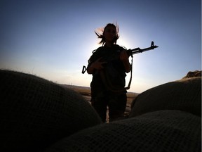 An Iranian Kurdish female member of the Freedom Party of Kurdistan (PAK) keeps a position in Dibis, some 50 kms northwest of Kirkuk, on September 15, 2014. The world's top diplomats pledged today to support Iraq in its fight against Islamic State militants by "any means necessary", including "appropriate military assistance", as leaders stressed the urgency of the crisis.