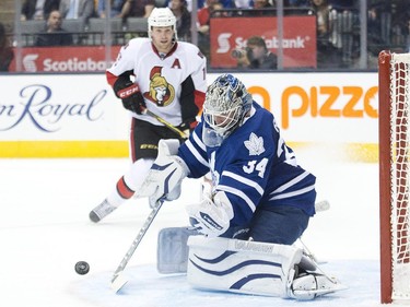 Toronto Maple Leafs goalie James Reimer (34) makes a save against the Ottawa Senators during first period pre-season NHL hockey action in Toronto on Wednesday, September 24, 2014.