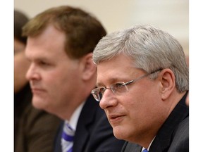 Minister of Foreign Affairs John Baird, left and Prime Minister Stephen Harper take part in an expanded bilateral meeting with Ukrainian Prime Minister Areseniy Yatsenyuk at the Cabinet of Ministers in Kiev, Ukraine, on Saturday, March 22, 2014.