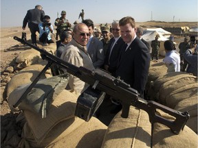 Canadian Foreign Affairs Minister John Baird, right, and Iraqi Deputy Minister Rowsch Nouri Sharways look at the ISIS positions from a front line bunker Thursday, September 4, 2014 in Kalak, Iraq.