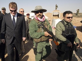 Canadian Foreign Affairs Minister John Baird, walks with Peshmurga soldiers at the front line position in the fight against ISIS Thursday, September 4, 2014 in Kalak, Iraq.