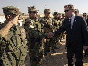 Canadian Foreign Affairs Minister John Baird, greets Peshmurga soldiers at the front line positions in the fight against ISIS Thursday, September 4, 2014 in Kalak, Iraq. THE CANADIAN PRESS/Ryan Remiorz