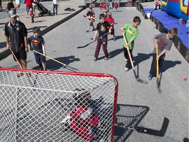 Kids play ball hockey at the Ottawa Senators Fan Fest at Canadian Tire Centre, Saturday, Sept. 27, 2014.