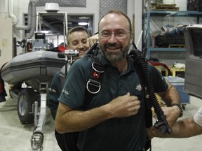 Marc-Andre Bernier, front, chief of the underwater archeology team at Parks Canada, and Jonathan Moore, senior underwater archeologist with Parks Canada, speak to reporters about the discovery of one of Franklin's lost ships as they prepare their equipment to return to Nunavut and the site of the wreck in Ottawa on Wednesday, September 10, 2014.