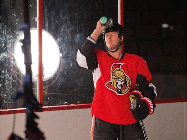 Marc Methot sprays water on his face while shooting promos for Sportsnet television as the Ottawa Senators are given medicals and tested for strength and conditioning.