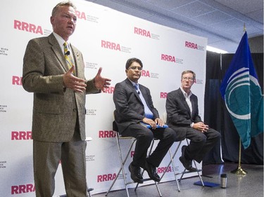 Mayoral candidate Mike Maguire, left, speaks during an all-candidates mayoral debate at the Carleton University Residence Commons while candidate Anwar Syed, centre, and incumbent, Jim Watson, right, looks on Tuesday September 23, 2014.