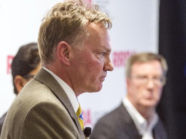 Mayoral candidate Mike Maguire, left, speaks during an all-candidates mayoral debate at the Carleton University Residence Commons while incumbent Jim Watson, right, looks on Tuesday September 23, 2014.
