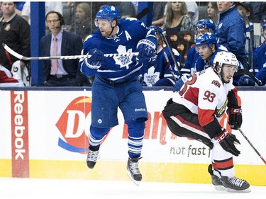 Toronto Maple Leafs forward Phil Kessel, left, avoids a hit from Ottawa Senators forward Mika Zibanejad during third period pre-season NHL hockey action in Toronto on Wednesday, September 24, 2014.