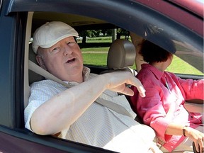 Mike Duffy speaks to reporters from his vehicle in Kensington, P.E.I. on  July 18, 2014.