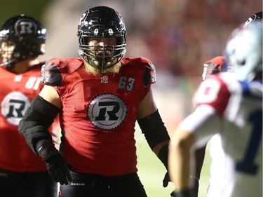 Jon Gott #63 of the Ottawa Redblacks stares down Marc-Olivier Brouillette #10 of the Montreal Alouettes as he walks up to the line of scrimmage during a CFL game at TD Place Stadium on September 26, 2014.