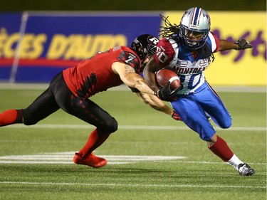 James Rodgers #80 of the Montreal Alouettes avoids a tackle by Eric Fraser #7 of the Ottawa Redblacks on a punt return during a CFL game at TD Place Stadium on September 26, 2014.