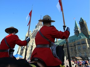 Mounted RCMP officers behind Parliament Hill.