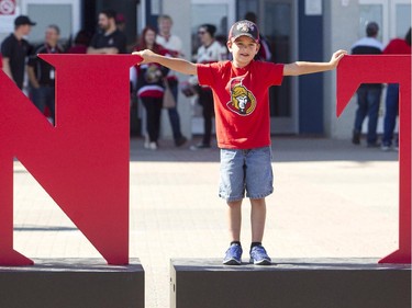 Nathan Emery gets his picture taken posing as the "I" in United at the Ottawa Senators Fan Fest at Canadian Tire Centre, Saturday, Sept. 27, 2014.