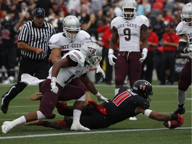 Nathaniel Behar of the Carleton Ravens dives for a touchdown during the Panda Game against the University of Ottawa Gee-Gees at TD Place on Sept. 20, 2014. The Ravens won the game 33-31 with a hail-mary pass.