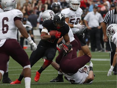 Nathaniel Behar of the Carleton Ravens evades tackles during the Panda Game against the University of Ottawa Gee-Gees at TD Place on Sept. 20, 2014. The Ravens won the game 33-31 with a hail-mary pass.