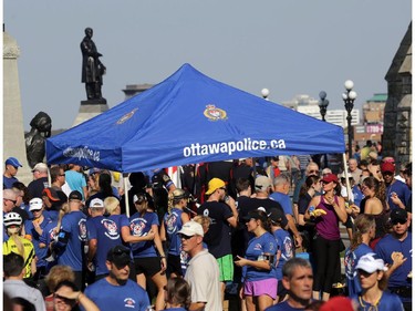National Peace Officers Memorial Run particpants gather behind Parliament Hill in Ottawa, Saturday, September 27, 2014. Police officers ran 460km from Toronto to Ottawa in support of their fallen comrades.
