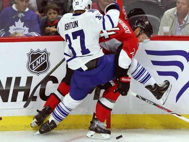 Ottawa Senators defenceman Mark Borowiecki (74) is checked by Toronto Maple Leafs forward Carter Ashton (37) during first period NHL pre-season hockey action in Ottawa on Wednesday, September 24, 2014.