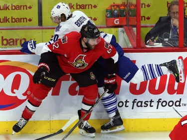 Ottawa Senators defenceman Eric Gryba (62) checks Toronto Maple Leaf forward David Booth (20) into the boards during first period NHL pre-season hockey action in Ottawa on Wednesday, September 24, 2014.