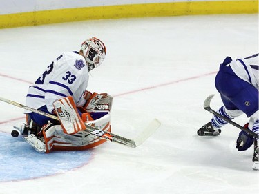 Ottawa Senators forward Bobby Ryan (6) is checked by Toronto Maple Leafs defenceman Andrew MacWilliam (57) as his shot goes past Maple Leafs goaltender Cal Heeter (33) during third period NHL pre-season hockey action in Ottawa on Wednesday, September 24, 2014. Ottawa beat Toronto 3-2.