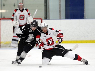 Ottawa 67's Troy Henley (3) and Gatineau Olympiques Jonathan Bourcier (26) battle for the puck during 1st period action at the Nepean Sportsplex in Ottawa, Saturday, September 6, 2014.