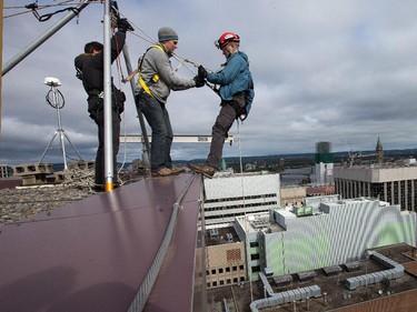 The moment of truth: Ottawa Citizen editor Blair Crawford leans back to begin a 20-storey rappel with the Easter Seal Drop Zone fundraiser.