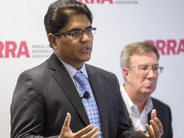 Ottawa mayoral candidate, Anwar Syed, speaks during an all-candidates mayoral debate while incumbent, Jim Watson, looks on at the Carleton University Residence Commons Tuesday September 23, 2014.