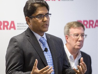 Ottawa mayoral candidate, Anwar Syed, speaks during an all-candidates mayoral debate while incumbent, Jim Watson, looks on at the Carleton University Residence Commons Tuesday September 23, 2014.