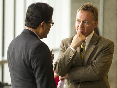 Ottawa mayoral candidates Anwar Syed, left, and Mike Maguire, right, chat before an all-candidates mayoral debate at the Carleton University Residence Commons Tuesday September 23, 2014.