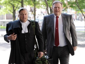 Brian Doyle and lawyer Justin Fogarty enter the Elgin Street courthouse in Ottawa in this file photo. Doyle is under fire from some investors in Golden Oaks, while others have lauded his efforts.