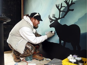 Artist Jamie "Janx" Johnston brings the night sky indoors at last year's Winterlude, putting the finishing touches on his cabin that  includes many winter themes. This year's artist theme concentrates on sports.