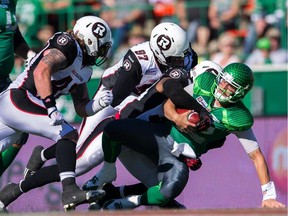 Wallace Miles #84 of the Ottawa Redblacks scores a late first half touchdown breaking the tackle of Tristan Jackson #38 of the Saskatchewan Roughriders in a game between the Ottawa Redblacks and Saskatchewan Roughriders in week 13 of the 2014 CFL season at Mosaic Stadium on September 21, 2014 in Regina, Saskatchewan, Canada.