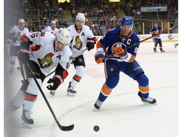 Ottawa Senators Clarke MacArthur, left, races for the puck with N.Y. Islanders John Tavares during first period pre-season NHL action in St. John's, N.L. on Monday September 22, 2014.