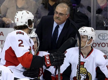 Ottawa Senators' Jared Cowen (2) receives instructions from head coach Paul MacLean during third period pre-season NHL hockey action in Winnipeg, Tuesday, September 30, 2014.