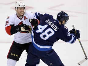 Ottawa Senators' Zack Smith (15) tries to hit Winnipeg Jets' Carl Klingberg (48) during third period pre-season NHL hockey action in Winnipeg on Tuesday, September 30, 2014.