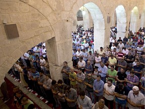 Palestinian Muslims hold Friday prayers in the Marwani prayer room (aka Solomon's Stables) located under the southeastern corner of the raised platform which holds the Dome of the Rock and al-Aqsa mosque, at the the al-Aqsa mosque compound in old city of Jerusalem on September 5, 2014.