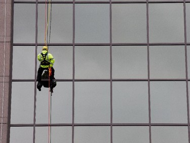 as participants rappel from the top of the Morguard Building at 280 Slater Street in the 5th annual Drop Zone Ottawa event which raises money for Easter Seals. September 22, 2014.