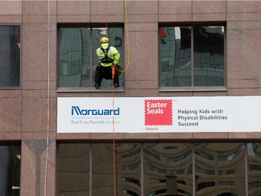as participants rappel from the top of the Morguard Building at 280 Slater Street in the 5th annual Drop Zone Ottawa event which raises money for Easter Seals. September 22, 2014.