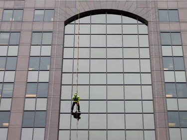 as participants rappel from the top of the Morguard Building at 280 Slater Street in the 5th annual Drop Zone Ottawa event which raises money for Easter Seals. September 22, 2014.