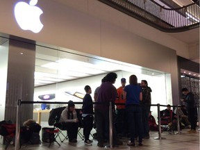 People eager to buy the iPhone 6 wait inside the Rideau Centre in Ottawa on Friday morning September 19, 2014.