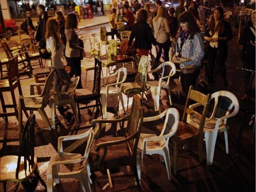 People manoeuvre  a labyrinth of chairs on George St. during Nuit Blanche in Ottawa, on Saturday, September 20, 2014.